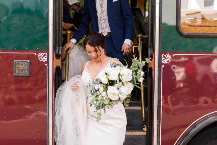 a group of people standing in front of a bus