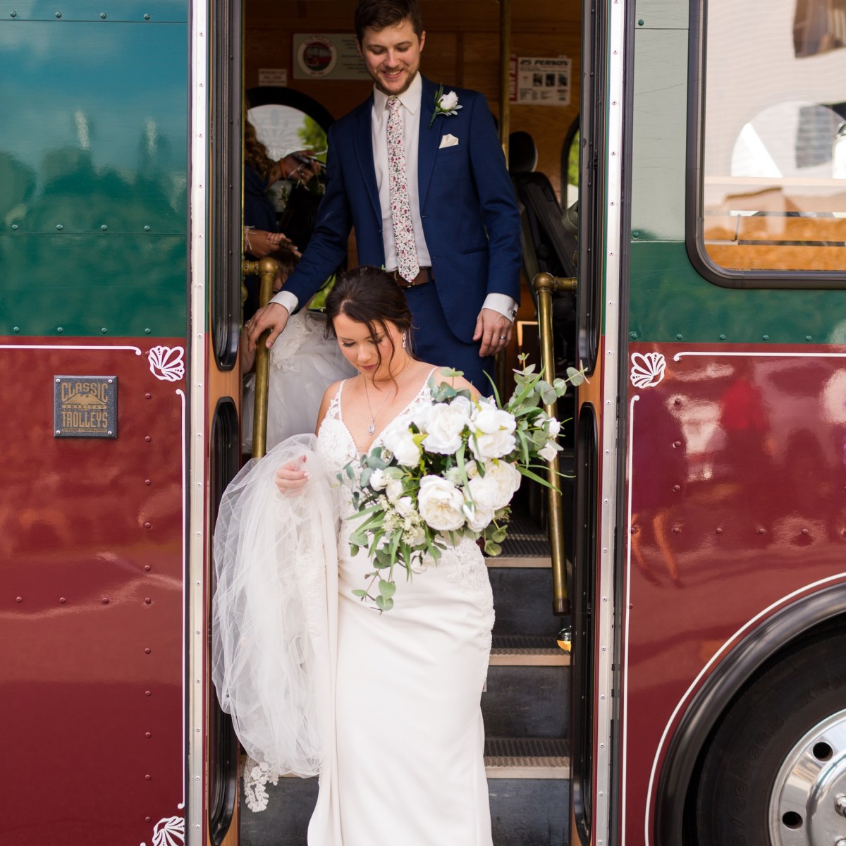 a group of people standing in front of a bus