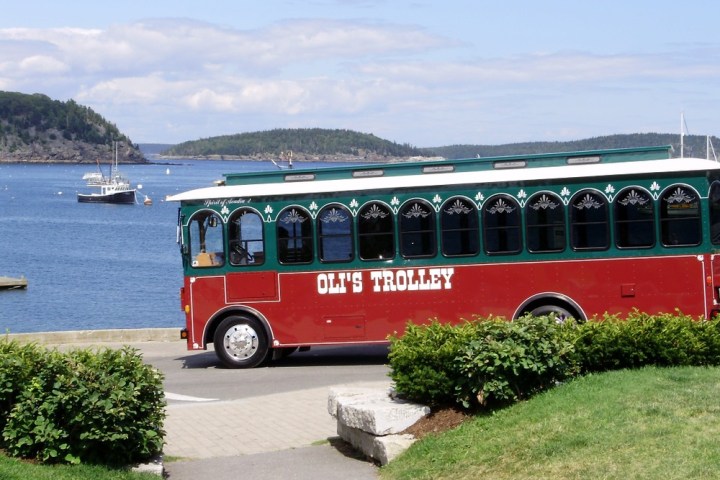 a bus parked in front of a body of water