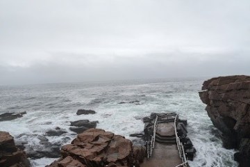 a rocky shore next to a body of water