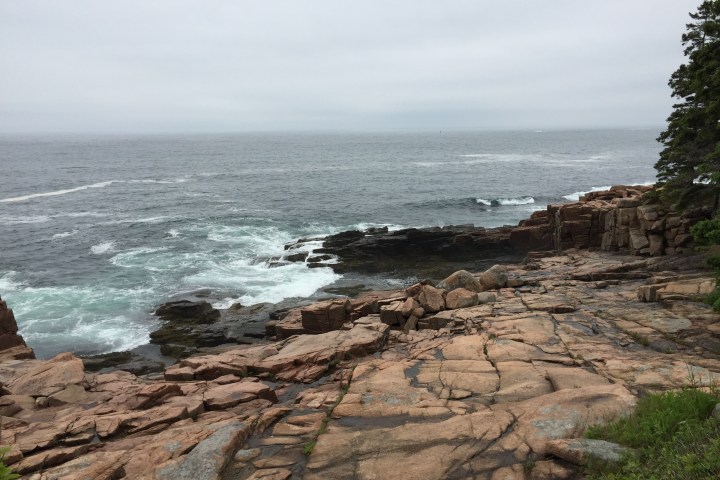 a rocky beach next to the ocean
