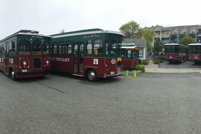 a passenger bus that is parked on the side of a road