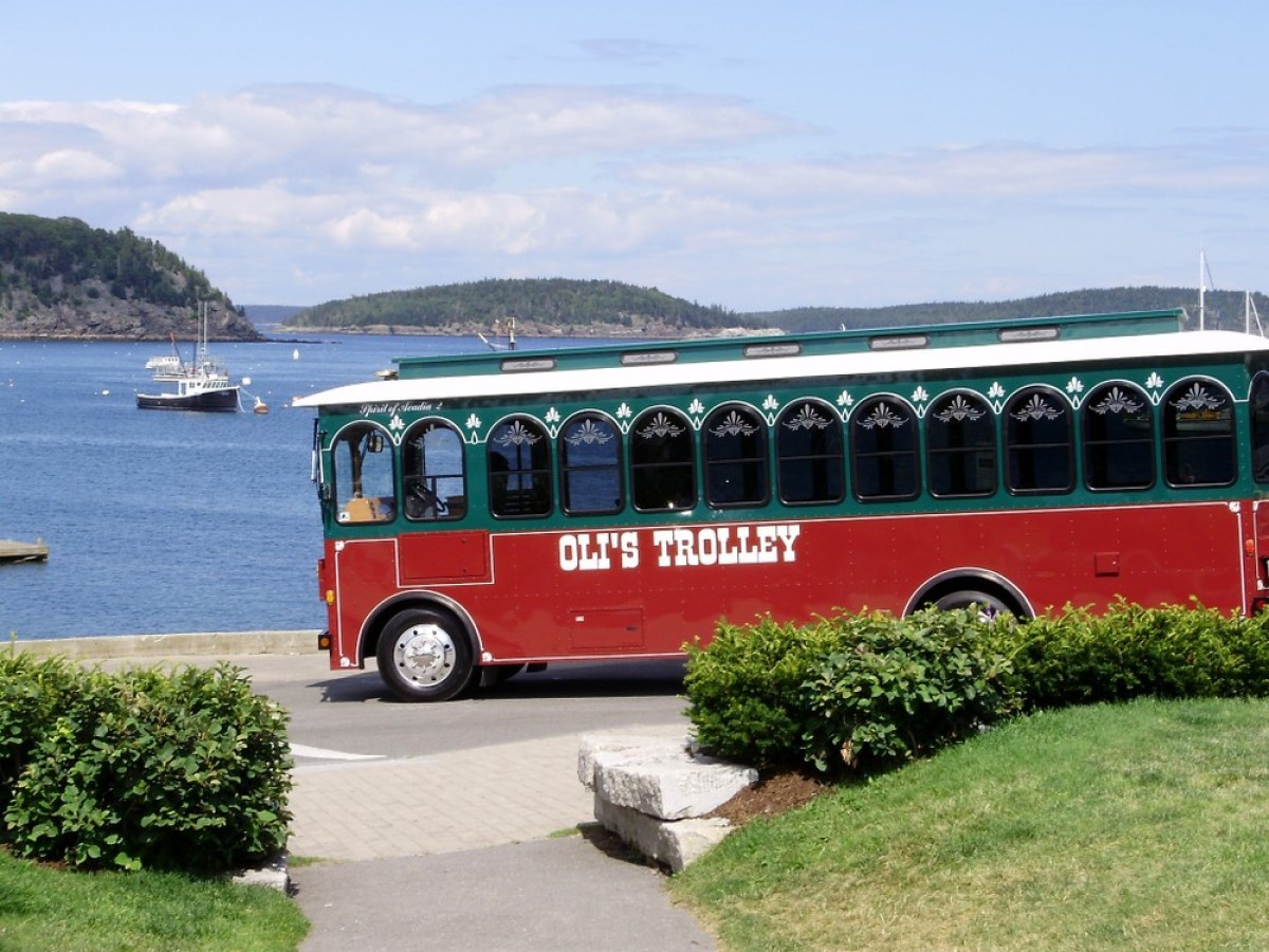 a bus parked in front of a body of water